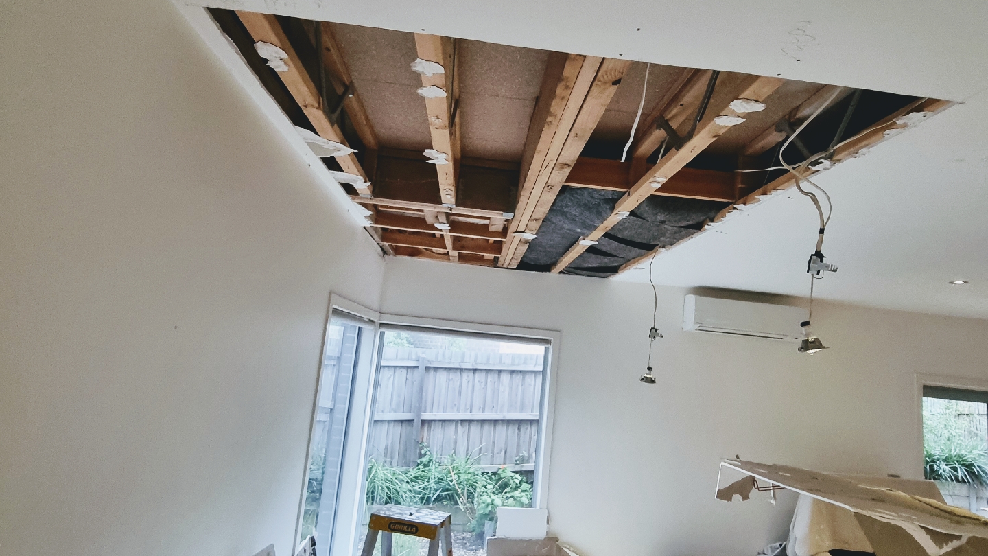 Living room ceiling opened to the joists