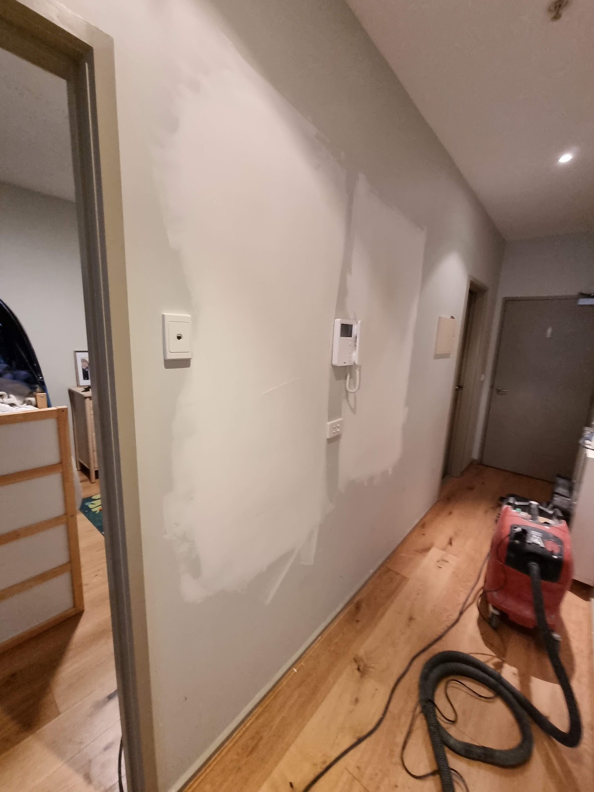 Hallway wall set and sanded smooth, dust extractor on the timber floor